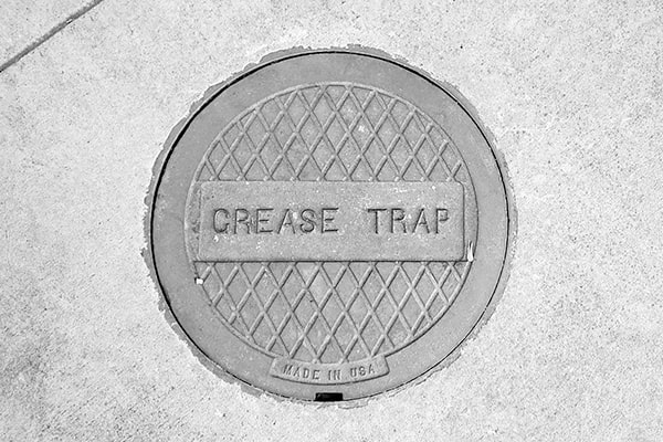 proper grease trap pumping prevents harmful pollutants and grease from entering the local water system